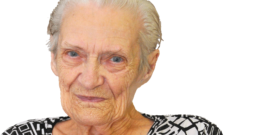 Elderly woman with short gray hair and a patterned blouse looks at the camera against a plain white background.